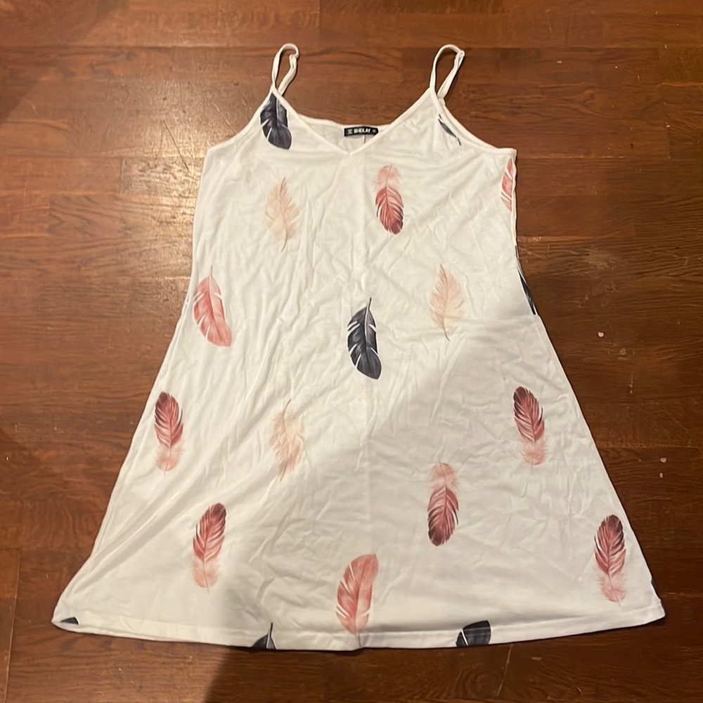 Worn once light material, white v cut dress with a detailed feathers on it